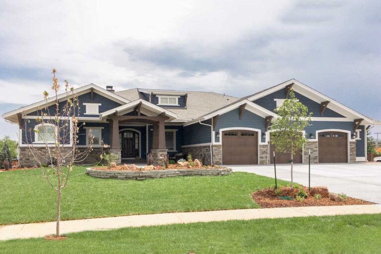 Craftsman house plan exterior. Features include a covered entry porch, multiple gables, and a three-car garage. Stone veneer accents the facade.