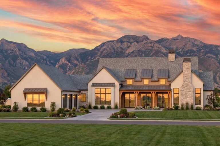 House plan exterior: Modern Farmhouse style, two stories, stone chimney, large windows, exposed wood beams, and metal dormers.